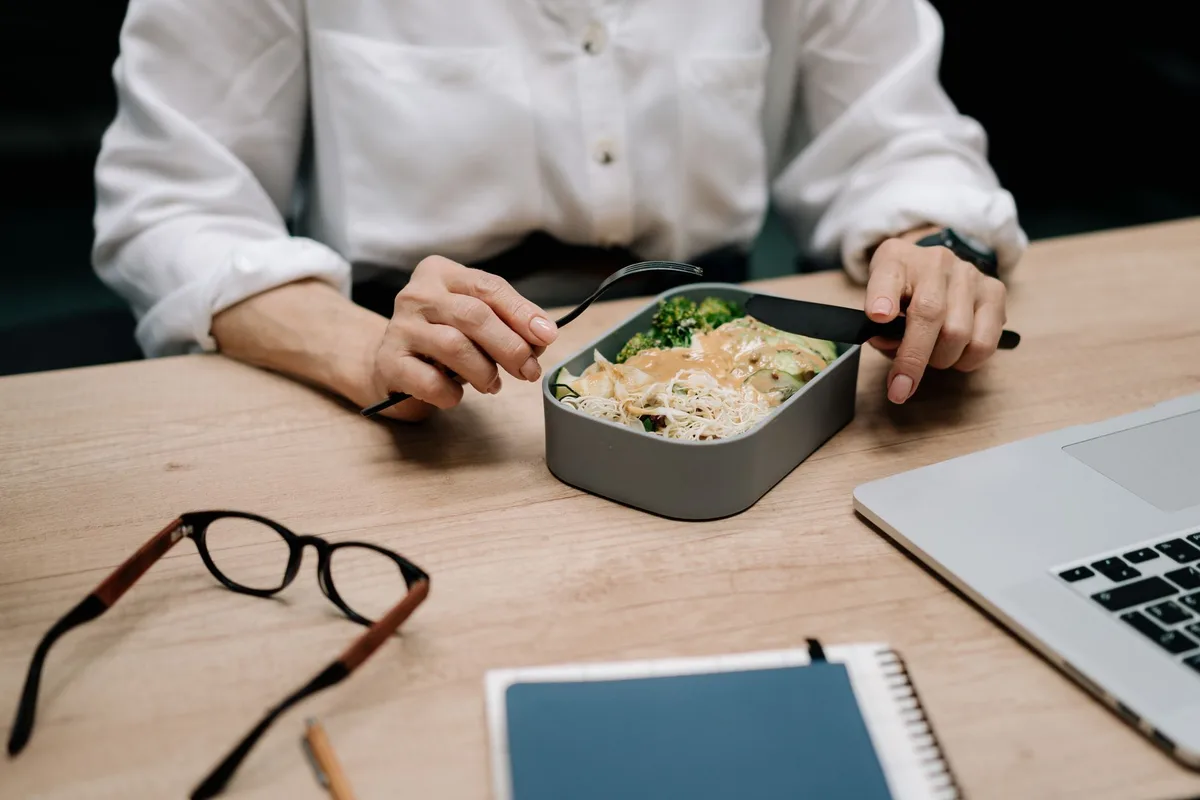 Boîte repas hermétique posée sur un bureau de travail avec compartiments