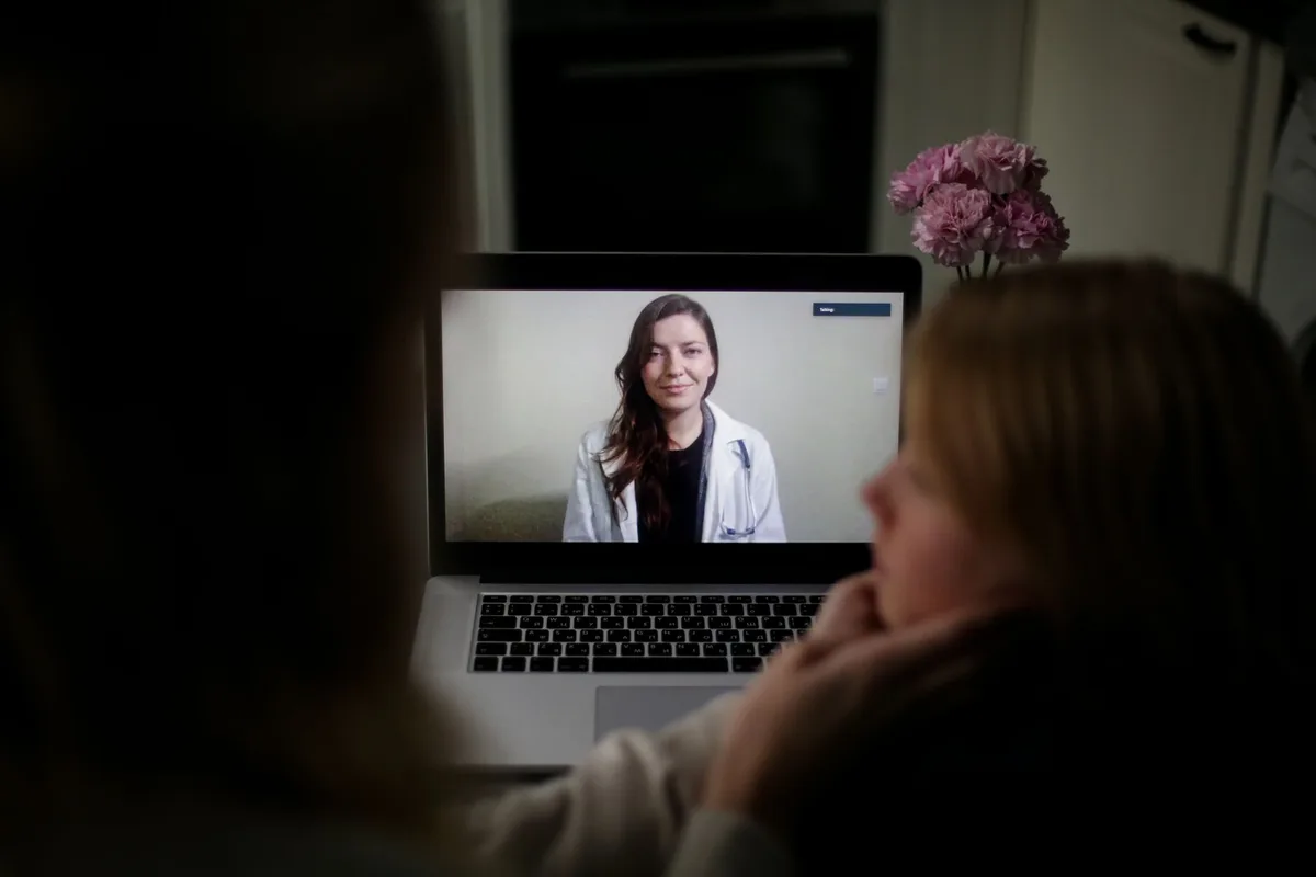 Consultation médicale en visioconférence sur écran d'ordinateur.