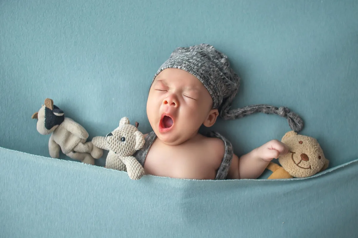 Bébé éveillé sur une couverture montrant des signes de fatigue pendant la journée